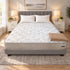 California King Breeze Cool Max 10" Medium Firm Tight top mattress on a gray upholstered bed with two white pillows and a tan knit throw, in a bedroom with white nightstands, table lamps and a framed landscape print