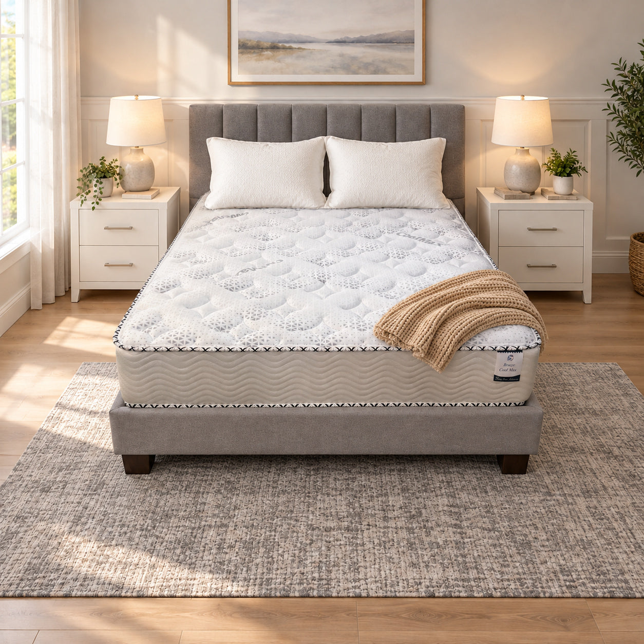 RV Short Queen Breeze Cool Max 10" Medium Firm Tight top mattress on a gray upholstered bed with two white pillows and a tan knit throw, in a bedroom with white nightstands, table lamps and a framed landscape print